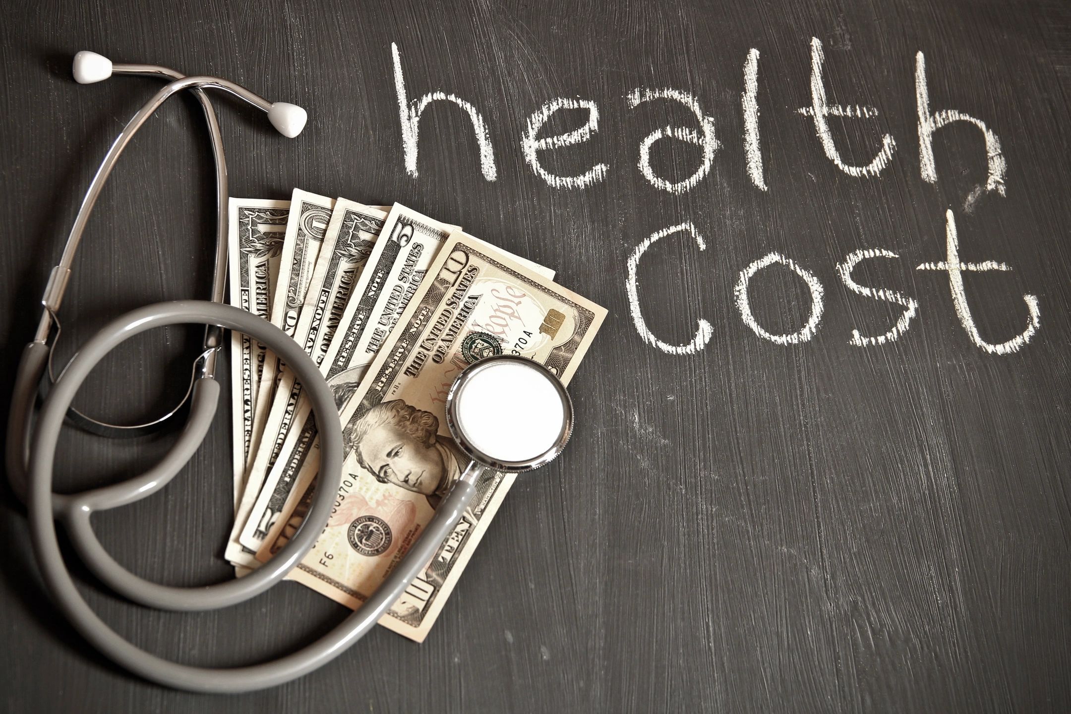 Stethoscope and dollar bills representing health costs
