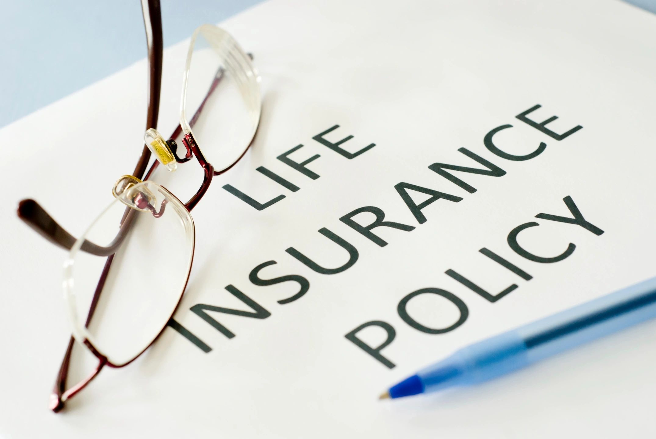 Life insurance policy document with glasses
